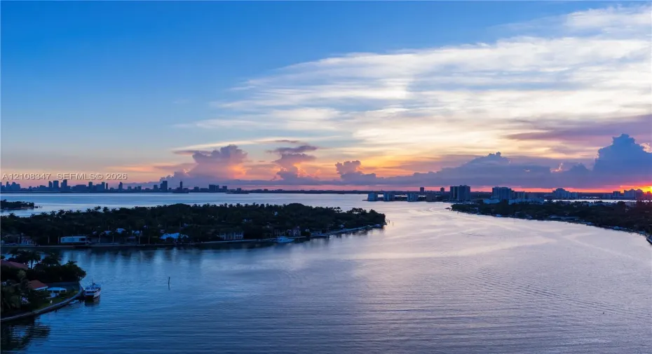 expansive bay views deep water access,skyline,open bayunder a sunset backdrop