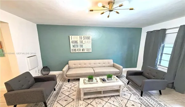 Multi-arm sputnik-style ceiling light fixture, tile flooring, and accent wall
