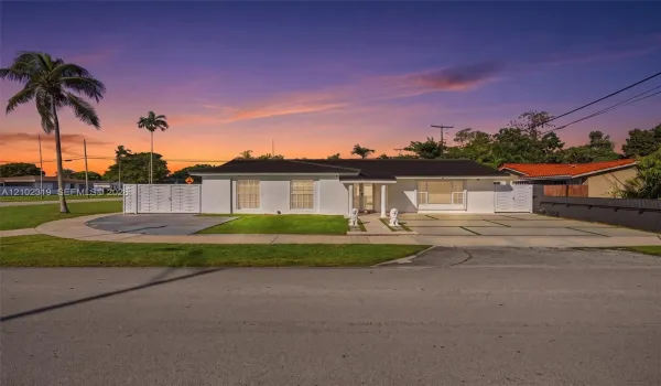 Single-story residence featuring a smooth stucco exterior, a segmented concrete driveway, white privacy fencing, and a multi-paneled​​‌​​​​‌​​‌‌​‌‌​​​‌‌​‌​‌​‌​​​‌​​ roofline