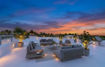 Expansive rooftop terrace featuring a smooth-finish deck, metal perimeter railing, and integrated wall-mounted lighting