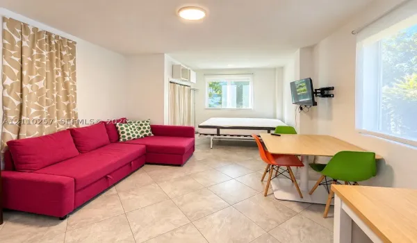 Interior space featuring large-format ceramic tile flooring, dual windows, and recessed ceiling lighting