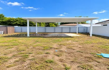 Backyard featuring a covered patio, concrete slab, and privacy fencing