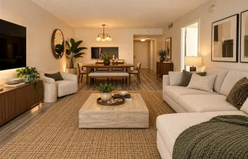 Open-concept living space featuring wood-finish flooring, recessed lighting, and a multi-arm chandelier