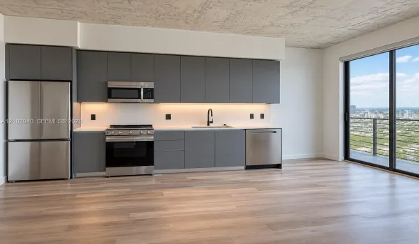 Modern kitchen featuring matte grey flat-panel cabinetry, stainless steel appliances, white stone-finish countertops, exposed concrete-texture ceiling, and floor-to-ceiling glass sliding doors