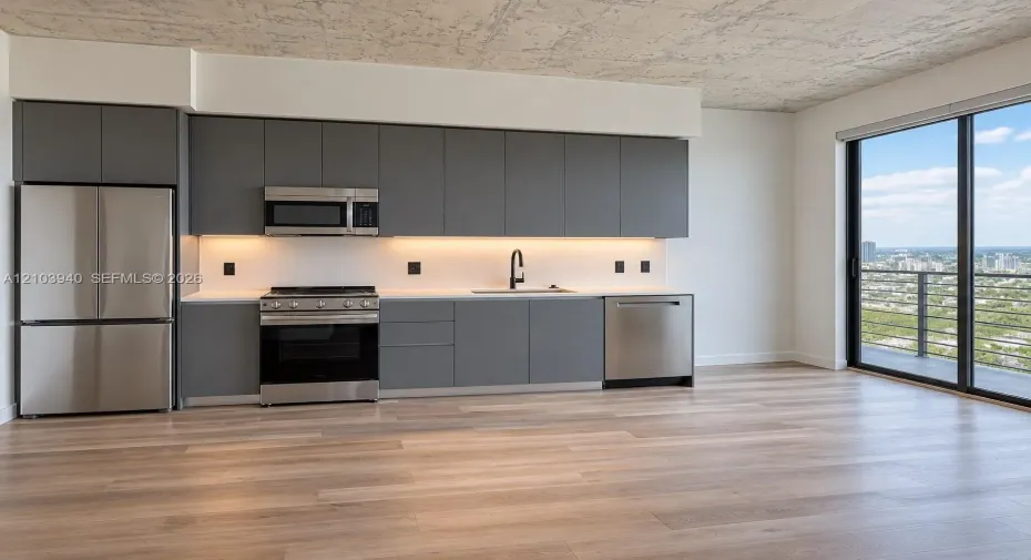 Modern kitchen featuring matte grey flat-panel cabinetry, stainless steel appliances, white stone-finish countertops, exposed concrete-texture ceiling, and floor-to-ceiling glass sliding doors