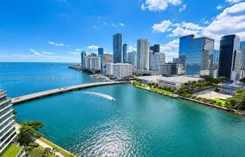 Aerial perspective featuring direct water frontage, a panoramic cityscape backdrop, and proximity to major thoroughfares