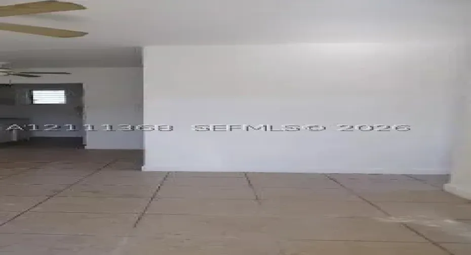 Interior space featuring ceramic tile flooring, neutral wall finishes, and a ceiling-mounted fan
