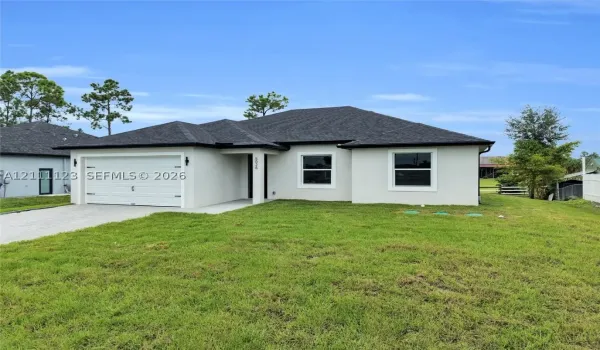 Front exterior of this new construction single-story home with stucco finish, shingle roof, and 2-car garage.