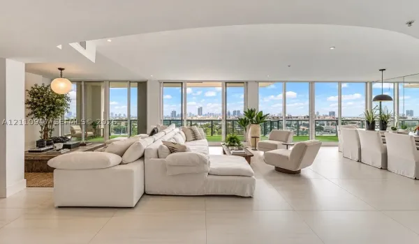 Open-concept interior featuring large-format tile flooring, recessed lighting, and expansive floor-to-ceiling glass windows