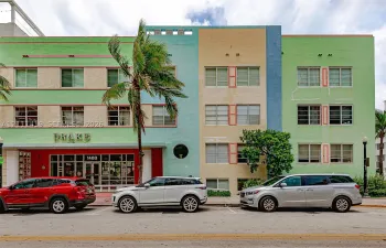 Art Deco exterior featuring a multi-toned pastel facade, inset rectangular windows, circular porthole accent, and prominent geometric roofline detailing