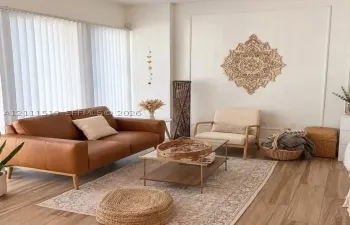 Room featuring wood-finish flooring, white walls with decorative molding, and floor-to-ceiling vertical blinds