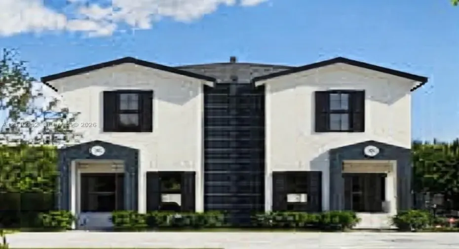 Two-story exterior featuring a high-contrast facade, dual-gabled rooflines, dark-trimmed window shutters, and symmetrical entryway surrounds