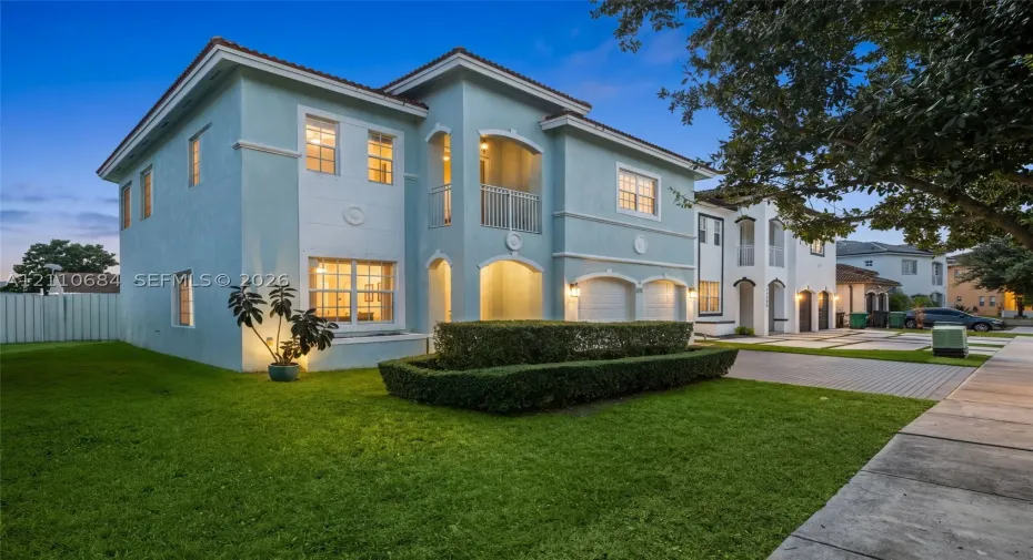 Two-story exterior,  balcony, a 2-car garage, and a paver-stone driveway