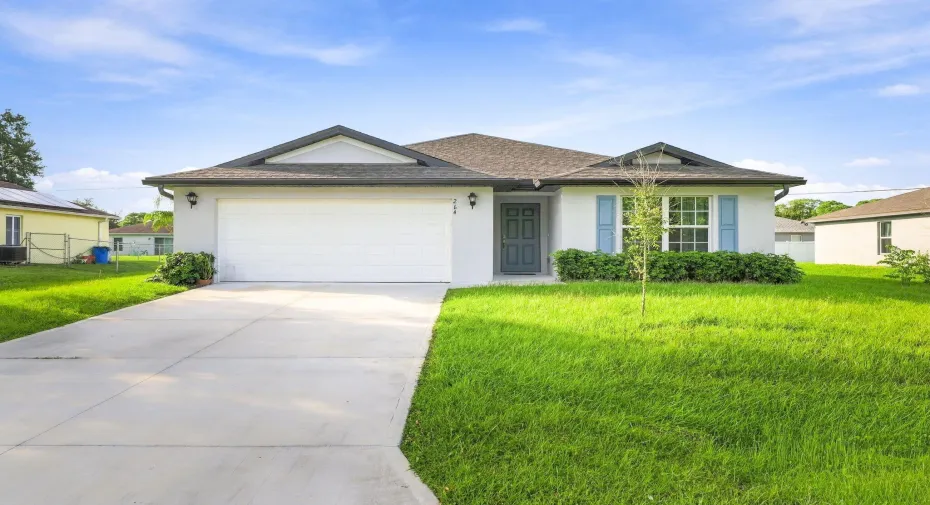 Welcome home to this 2024-built concrete block home with an attached garage and long driveway.