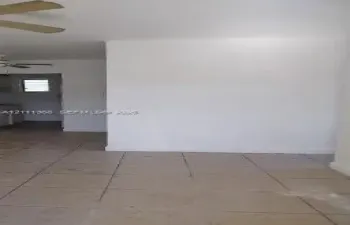 Interior space featuring ceramic tile flooring, neutral wall finishes, and a ceiling-mounted fan