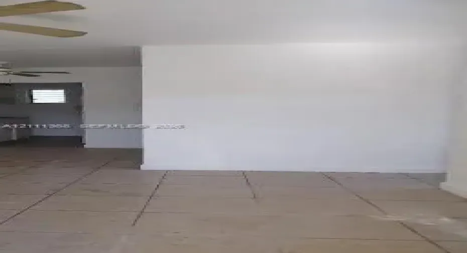 Interior space featuring ceramic tile flooring, neutral wall finishes, and a ceiling-mounted fan