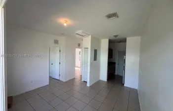 Interior space featuring neutral wall paint, large-format tile flooring, louvered closet doors, and recessed ceiling lighting