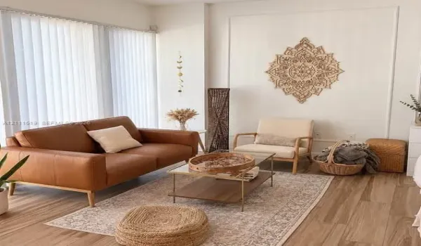 Room featuring wood-finish flooring, white walls with decorative molding, and floor-to-ceiling vertical blinds