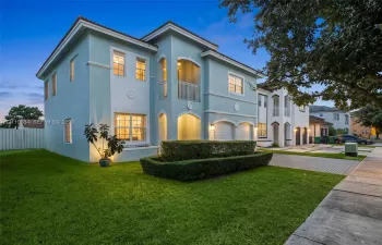 Two-story exterior, balcony, a 2-car garage, and a paver-stone driveway