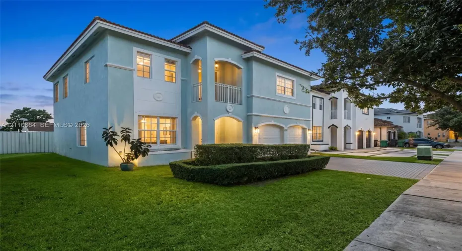 Two-story exterior, balcony, a 2-car garage, and a paver-stone driveway
