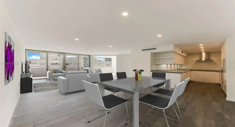 Open-concept living space featuring wood-finish flooring, recessed lighting, floor-to-ceiling glass sliding doors, and a kitchen equipped with flat-panel cabinetry, a stainless steel range hood, and solid-surface countertops