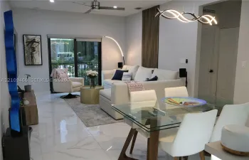 Large-format polished tile flooring, recessed ceiling lighting, contemporary metal-finish ceiling fan, wood-slat wall paneling, and a geometric LED statement light fixture