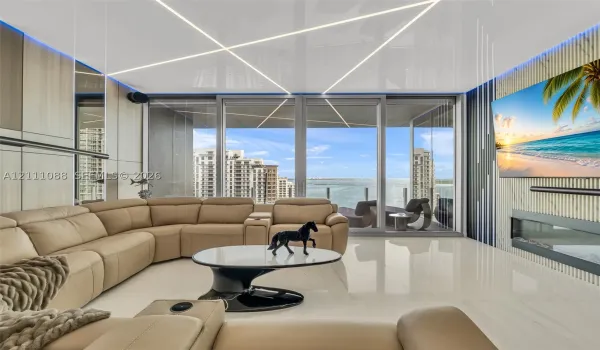 Living space featuring large-format tile flooring, linear ceiling lighting, floor-to-ceiling glass sliding doors, wood-finish wall paneling, and an integrated linear fireplace