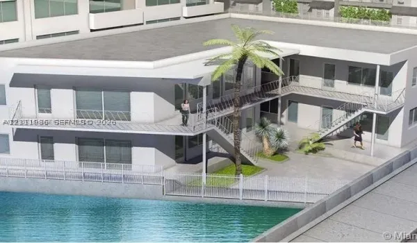 Multi-level exterior featuring white stucco siding, metal railing balconies, concrete courtyard hardscaping, and built-in metal staircases overlooking a waterfront boundary
