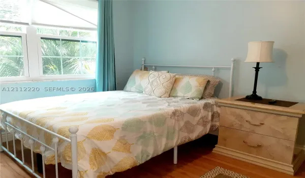 Room featuring hardwood flooring and a multi-pane window assembly