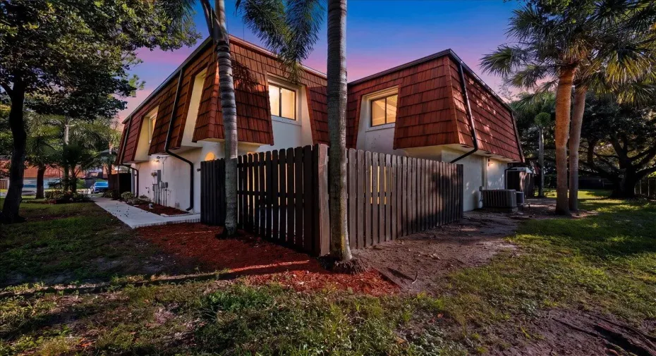Surrounded by mature palms and lush greenery, this charming townhome welcomes you to South Florida living.