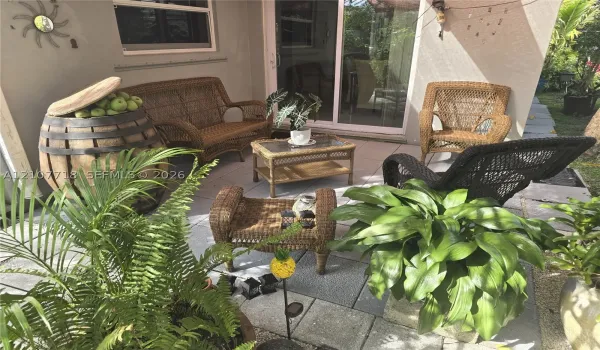 Paved patio featuring large-format concrete tiles and a sliding glass door