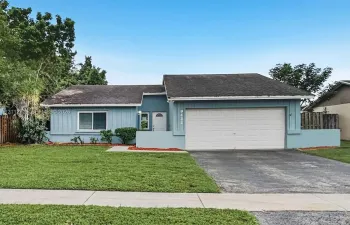 Single-story residence featuring horizontal lap siding, an attached two-car garage, an asphalt-shingled roof, and a paved driveway
