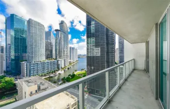 Private balcony featuring a concrete floor and a glass-paneled railing