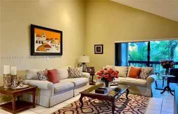 High vaulted ceiling, tile flooring, and oversized sliding glass doors