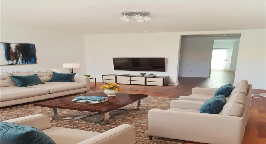 Neutral wall finishes, wood-finish flooring, and a multi-bulb flush-mount ceiling fixture