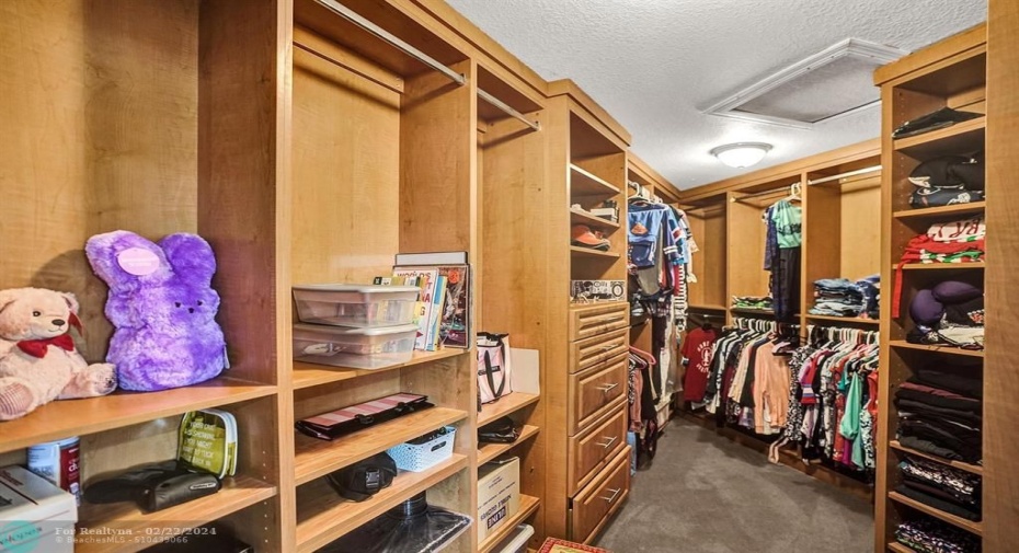 Plenty of storage and hanging space in this walk in closet in the primary bedroom