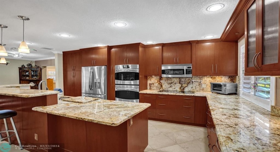 Open kitchen and living area. Granite counters, stainless appliances, custom cabinetry.