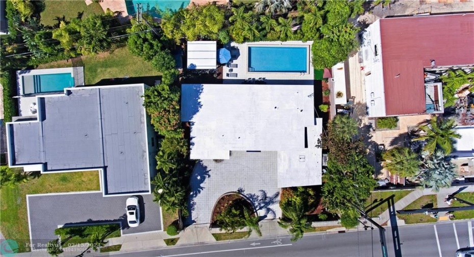 Ariel shot of property with view of oversized pool.