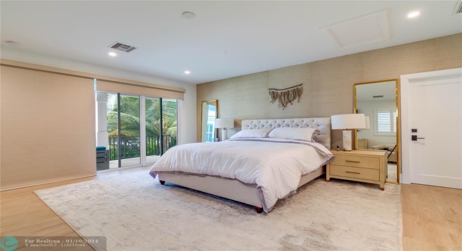Large and luxurious master bedroom suite with private balcony overlooking the patio area and the Intracoastal.