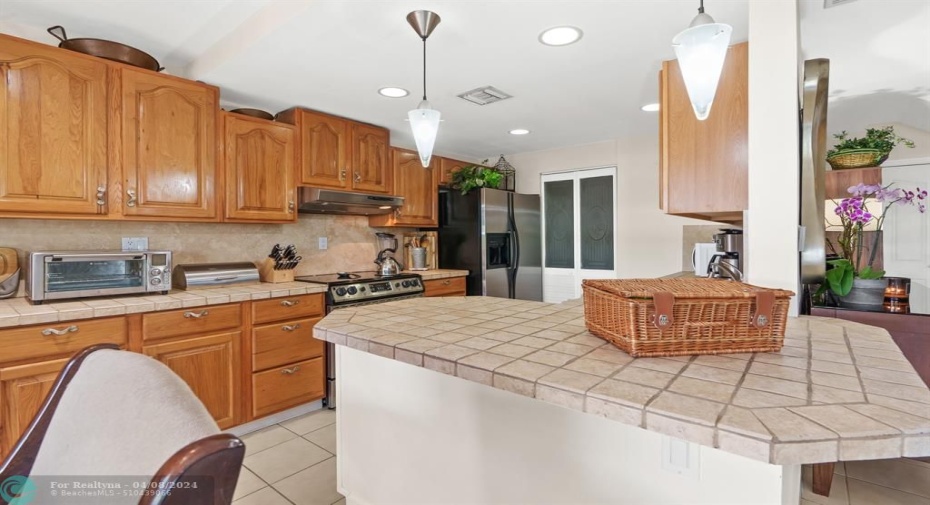 Open concept kitchen with counter seating has views to your private patio.