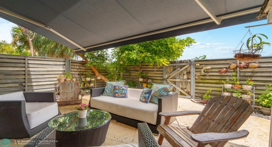 Fully fenced, private patio with retractable awning.
