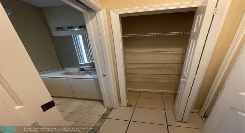 Linen Closet in next to washer and dryer and powder room
