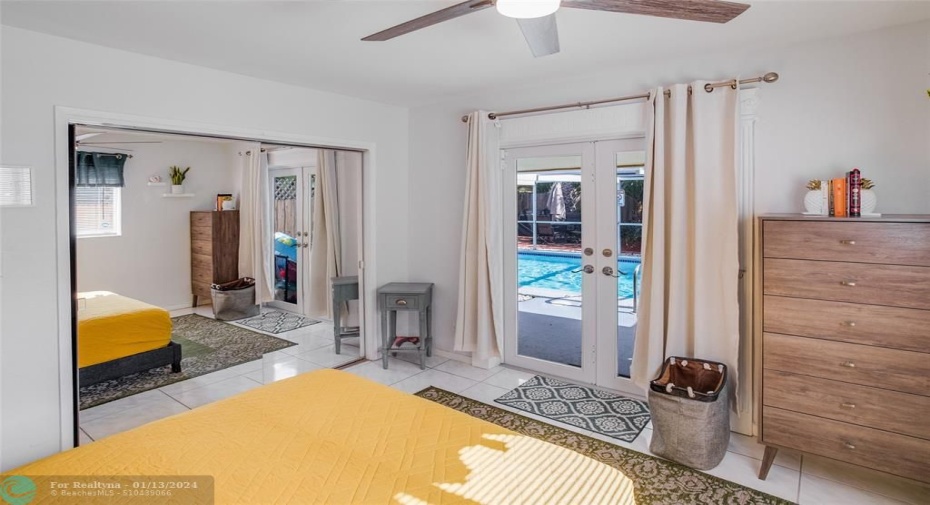 Guest room with pool area access through impact French Doors