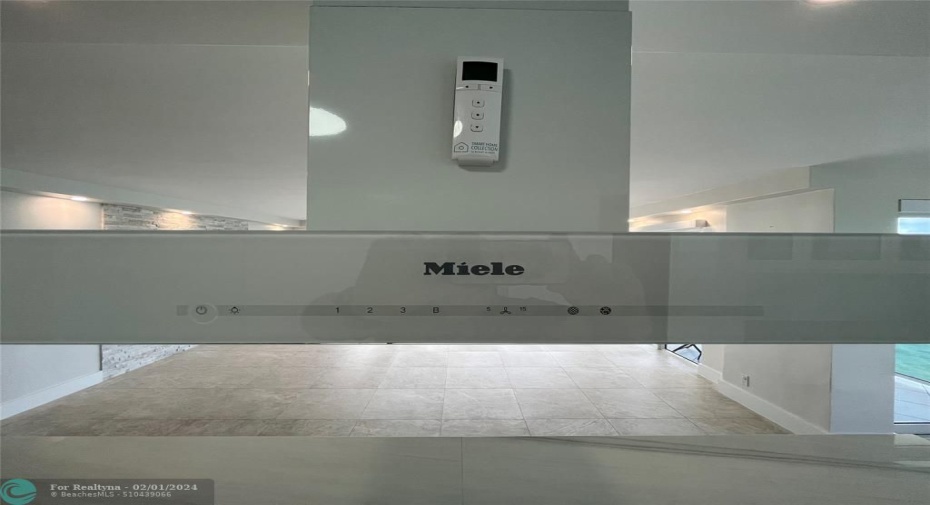 Miele® cooking hood. The remote seen in the photograph controls the blinds with five separate controls.