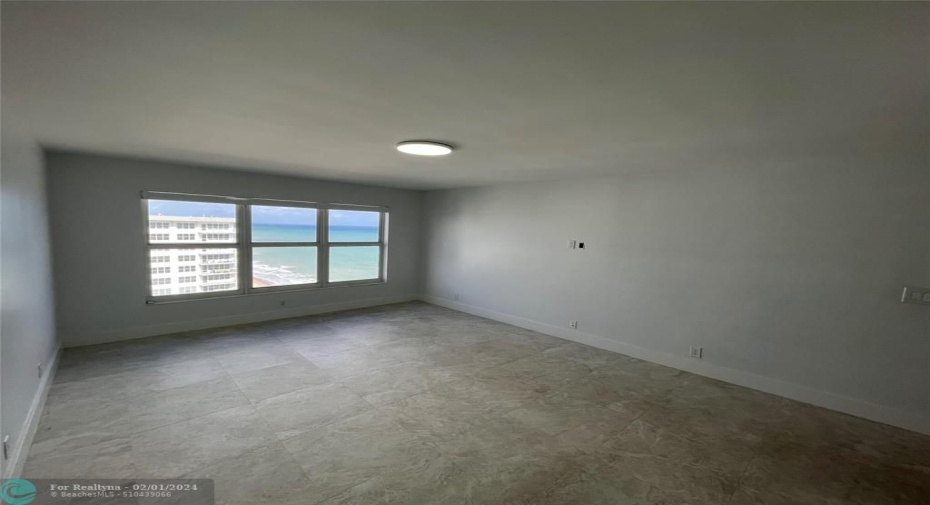 The large master bedroom offers a view of the ocean.