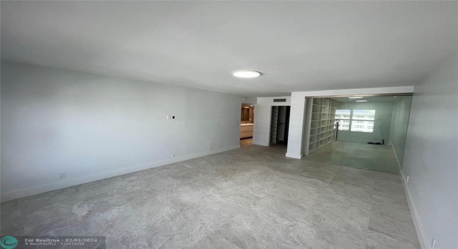 The master bedroom includes a separate sliding glass door room which may be utilized as an office or den.