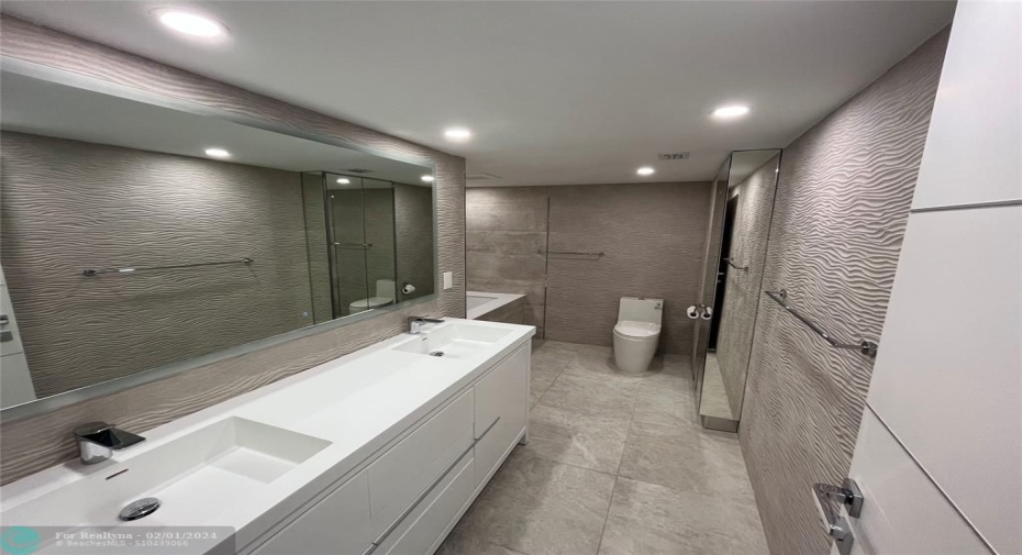 The large master bath includes two sinks and plenty of storage.