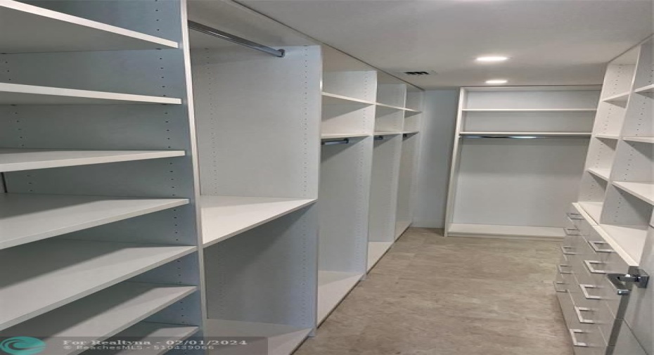 The master bedroom includes a large walk-in closet with custom built-in shelving.