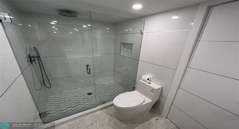The hall bathroom includes a step-in full-glass shower.