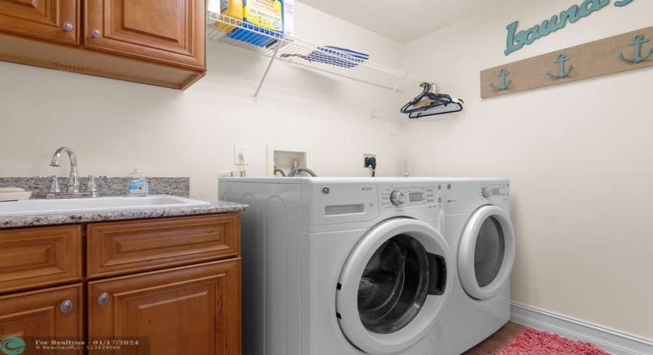Large laundry room with cabinets and sink.